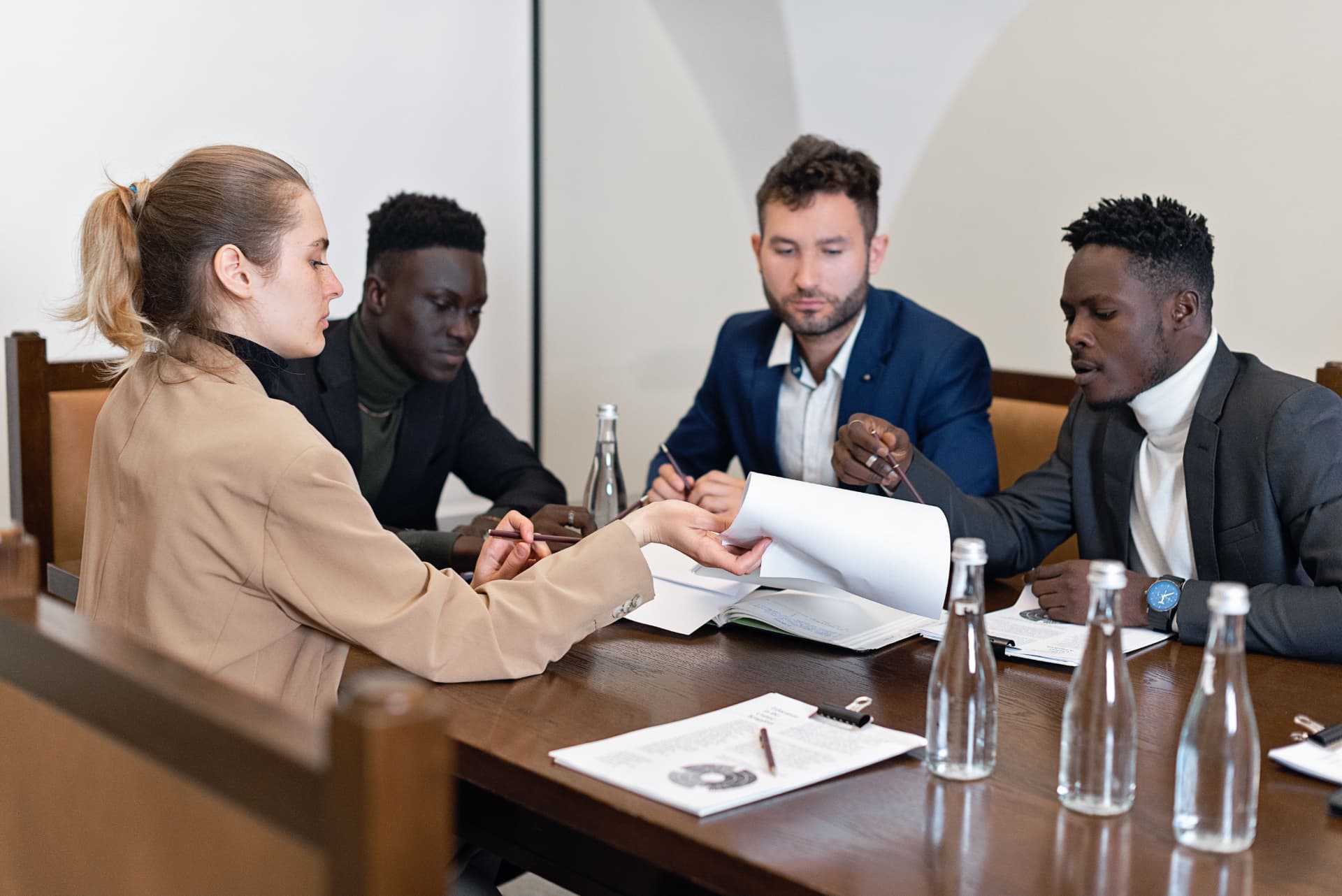 A leader presenting to his executive team around a boardroom table